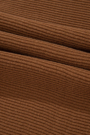 Brown ribbed knit pullover sweater with balloon sleeves.