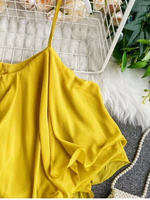 Yellow ruffled camisole with spaghetti straps and delicate ruffles.