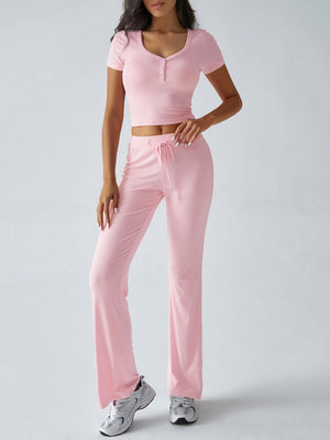 Blush pink button-front crop top and flared lounge pants with drawstring waist.