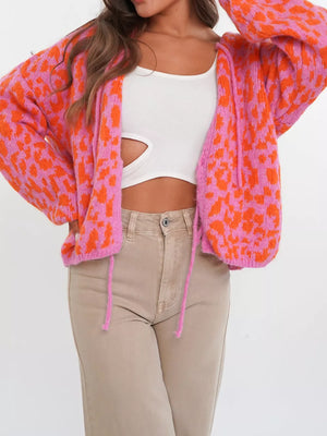 Vibrant leopard print tie-front cardigan in pink and burnt coral with balloon sleeves.