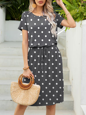 Gray polka dot midi dress with drawstring waist and short sleeves.
