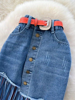 Patchwork denim midi skirt with button front, frayed hem, and striped fringe detail.