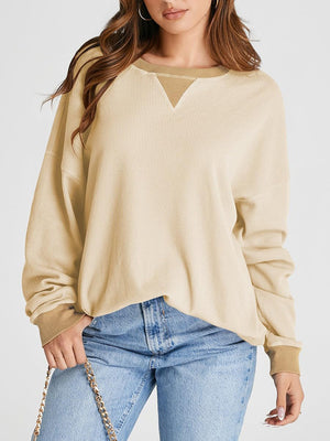 Tan waffle knit raglan sleeve sweatshirt with contrast V-neck detail.