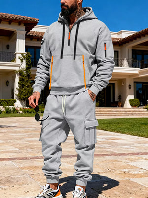 Men's light gray half-zip hoodie and cargo sweatpants set with orange zipper accents.