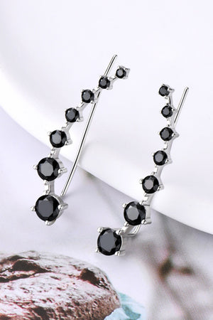 Black diamond ear climbers with silver metal setting, featuring a graduated cluster of round black stones.