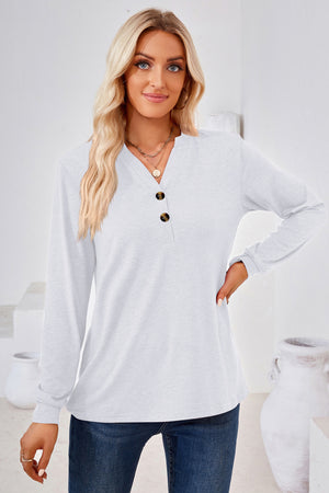 White henley neckline jersey top with button detail and long sleeves.