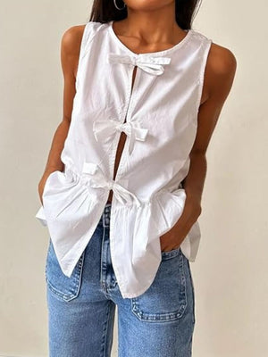 White peplum blouse with bow tie front detail and round neckline