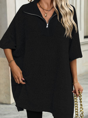 Black knit poncho with asymmetrical hem and zip-neck collar