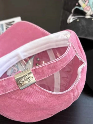 Pink cotton baseball cap with embroidered detail and metal strap adjuster