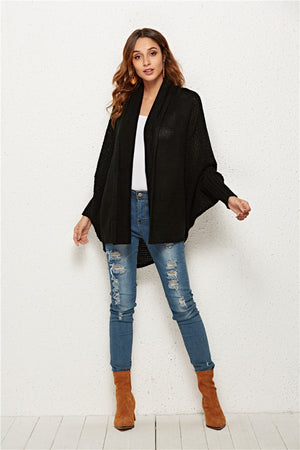 Black acrylic knit cocoon cardigan with batwing sleeves and waterfall neckline.