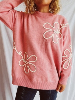 Watermelon pink acrylic knit sweater with white floral outline detail.