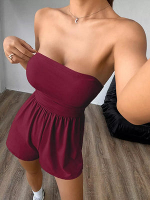 Burgundy strapless ruched waist romper with elastic waist and short shorts.