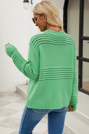 Green open-knit mock neck sweater with textured stripes and ribbed cuffs.