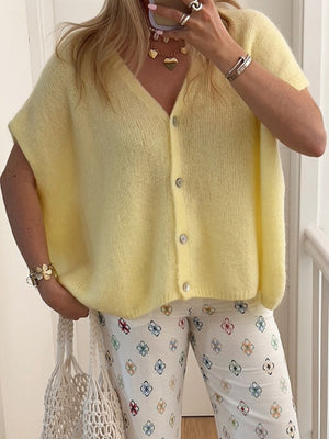Pastel yellow mohair button cardigan with cap sleeves and a V-neck.