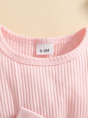 Pink ribbed baby set with a bow detail.