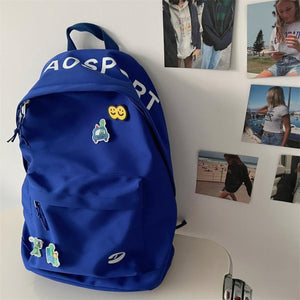 Klein Blue nylon backpack with utility pocket and fun patches.