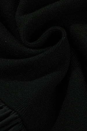 Black ribbed bodice peplum top with a ruffled hem detail.