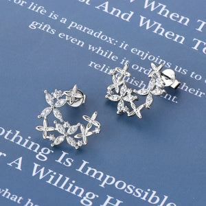 Silver floral cluster stud earrings with sparkling cubic zirconia accents.
