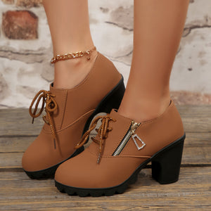 Brown lace-up high heel pumps with side zipper and chunky block heel.