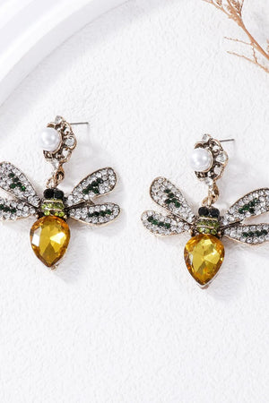 Jeweled dragonfly chandelier earrings with yellow gem body and crystal wings.