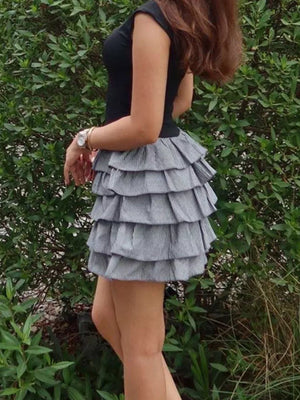 Black cap sleeve dress with a tiered ruffle skirt in grey and white pinstripe.