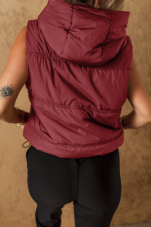 Burgundy quilted hooded puffer vest with adjustable drawcord hem.