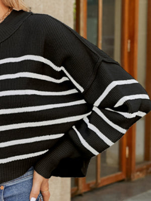 Black and white striped acrylic knit sweater with balloon sleeves and a collar.