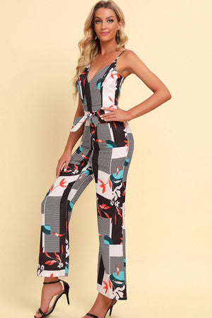 Geometric print cami jumpsuit with tie waist and v-neckline in white.