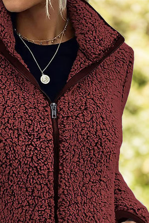 Burgundy teddy fleece zip-up jacket with a stand-up collar and full zipper.