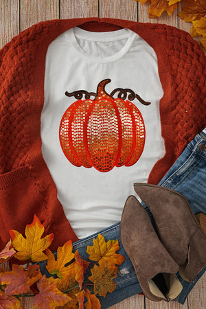 White tee with orange sequin pumpkin appliqué and brown stem detail.