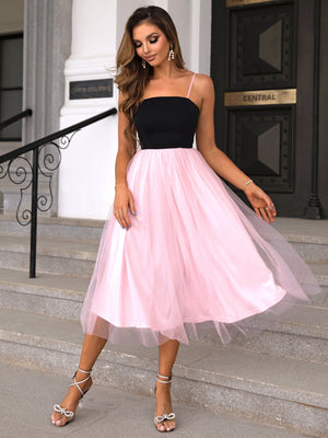 Pink tulle skirt midi dress with black bodice and spaghetti straps.
