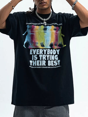 Men's black cotton graphic t-shirt with colorful figures and text print.
