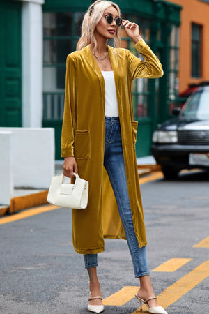 Mustard velvet duster coat with pockets, open front, long sleeves, and floor length.