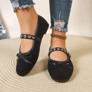 Black Mary Jane flats with bow detail and eyelet strap.