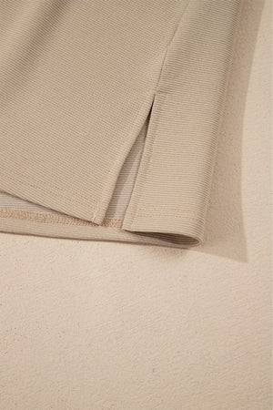 Khaki blouse with textured fabric and side slit detail.