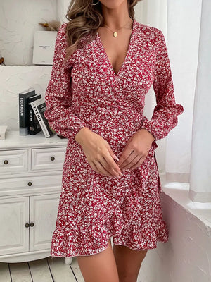 Red floral wrap mini dress with V-neck, long sleeves, and ruffled hem.