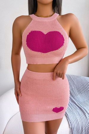 Pink knit halter crop top and mini skirt set with intarsia hearts.