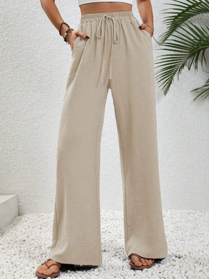 Caramel textured palazzo trousers with drawstring waist and pockets.