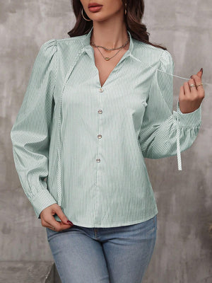 Green striped blouse with puff sleeves, V-neck, and tie cuffs.