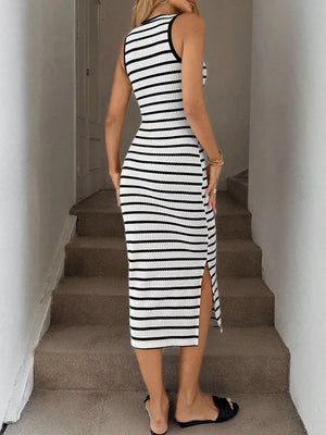 Sleek black and white striped bodycon midi dress with a high slit and sleeveless design.