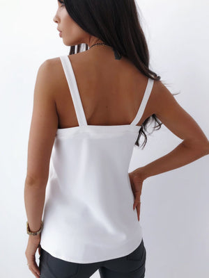 White silky cami top with adjustable straps and a square neckline.