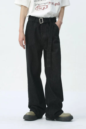 Black wide-leg denim jeans with belt detail and silver buckle.