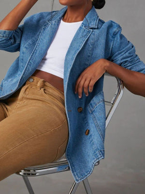 Denim blazer in dusty blue with structured shoulders and buttoned front, styled with a white crop top and tan pants.