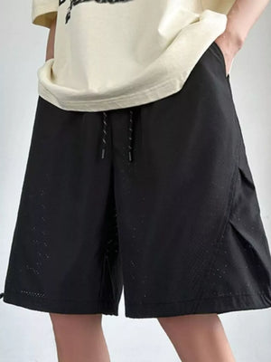 Black chino shorts with drawstring waist and perforated detail.