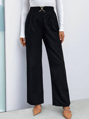 Black wide leg trousers with a gold buckle detail at the high waist.