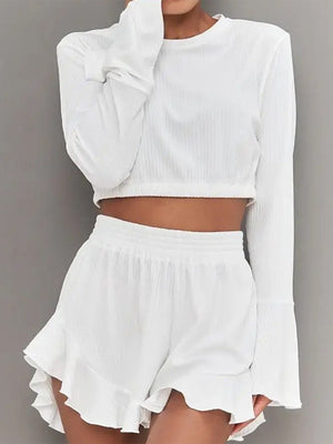 White ribbed crop set with flared sleeves and ruffled shorts