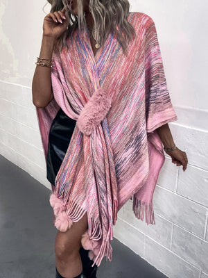 Pink knit wrap coat with multicolor stripes and faux fur pom-pom details.