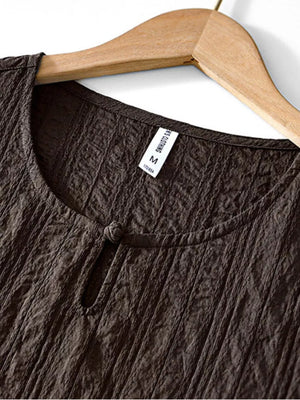 Textured chocolate short sleeve men's blouse with round neckline and knot detail.