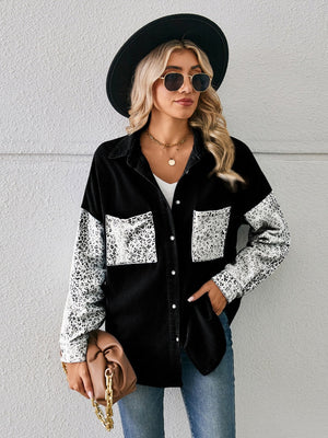 Black denim overshirt with leopard print sleeves and pockets, button front, casual style.