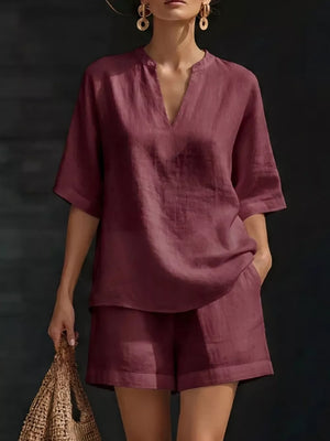 Effortless oversized two-piece set in fuchsia pink with V-neck top and shorts.